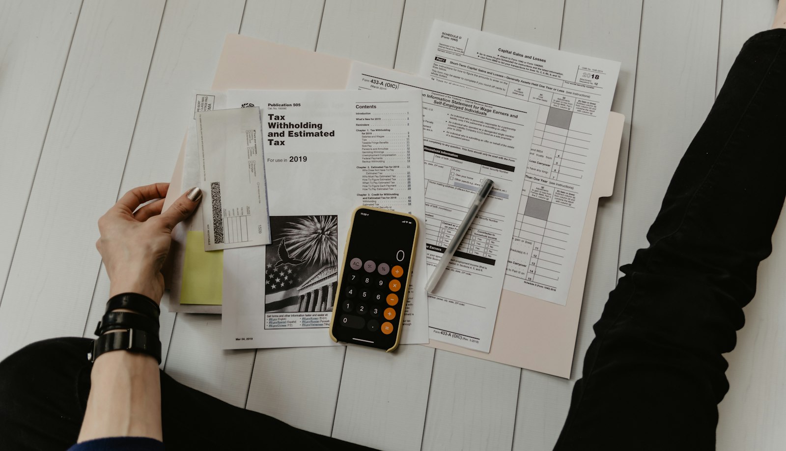 a calculator and papers on a desk, used beside the notes on Cart